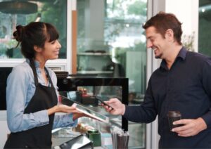 Image of a person accepting a payment with a POS system