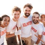 Image of a group of volunteers picking up trash at the beach for a nonprofit organization